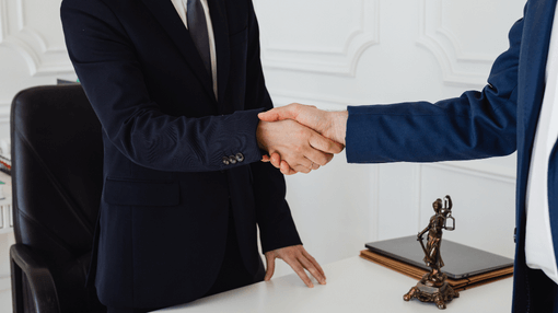 2 lawyers shaking hands
