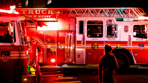 Firefighter infront of an NYFD Fire truck