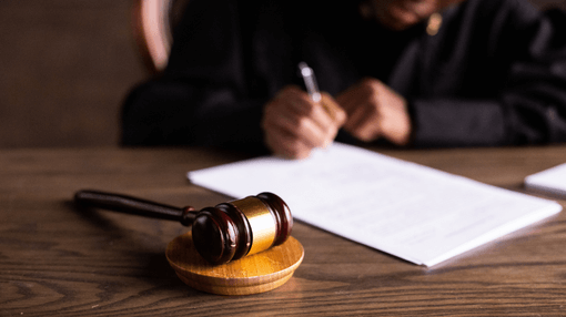 gavel infront of a judge writing on paper
