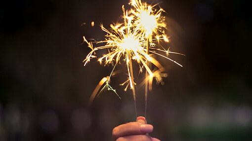 Person holding new years sparklers